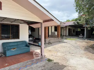 Charming single-story home with spacious outdoor area and cozy porch seating.