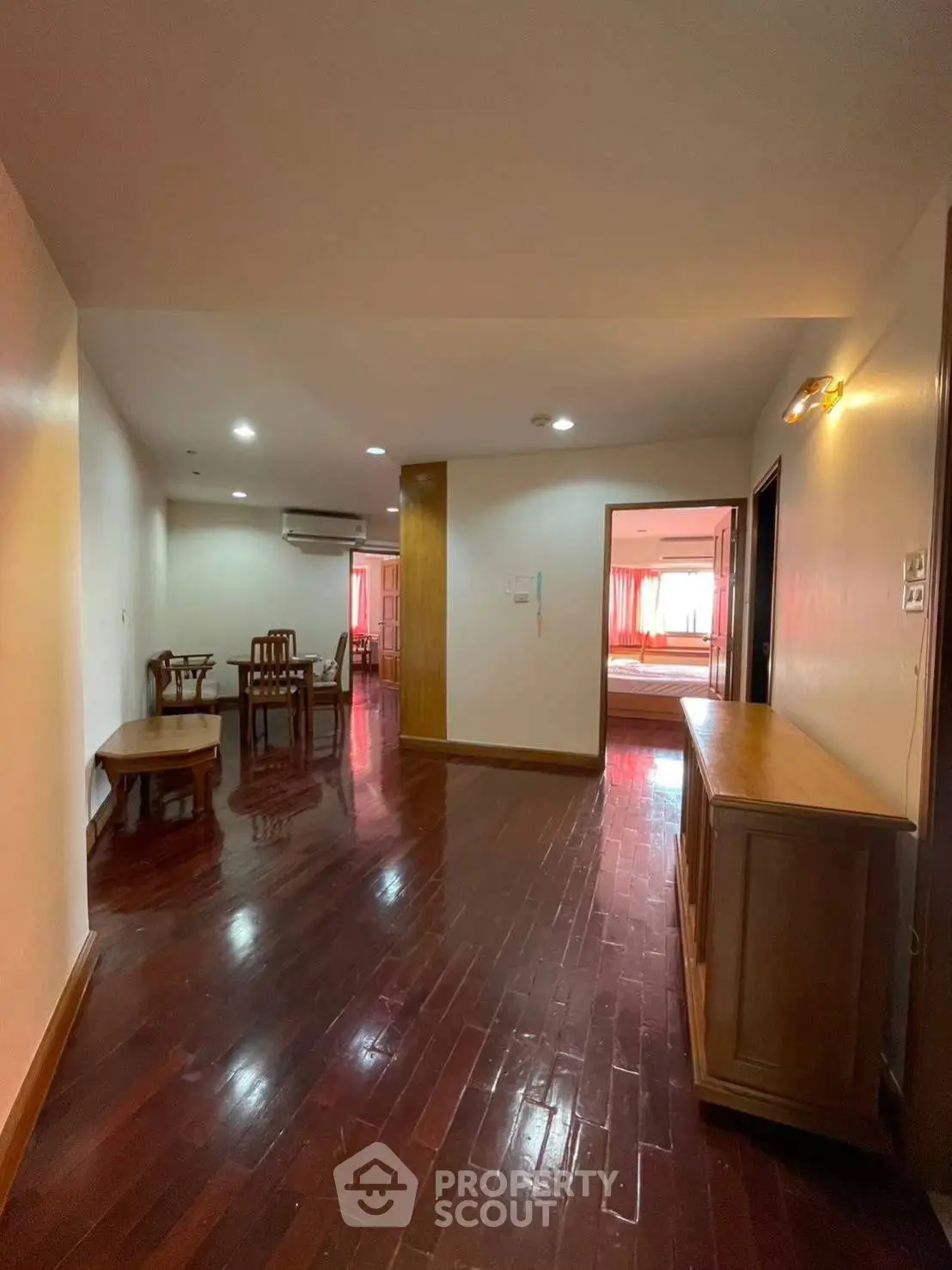 Spacious apartment with polished wooden floors and elegant dining area