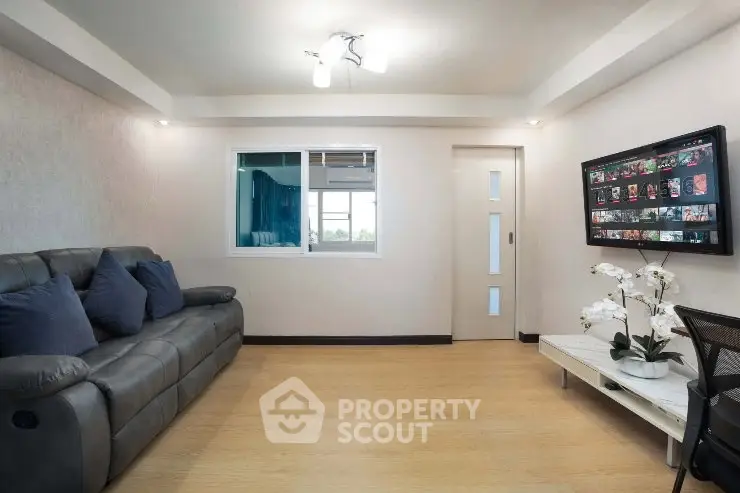 Modern living room with sleek sofa and stylish decor, perfect for relaxation and entertainment.