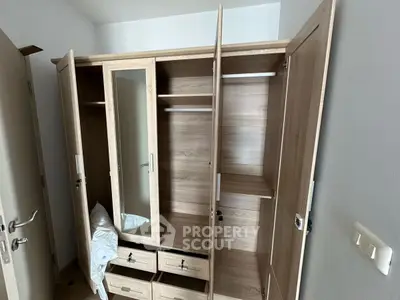 Spacious wooden wardrobe with mirror in modern bedroom, perfect for ample storage and stylish organization.