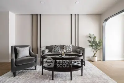 Elegant living room with modern furniture and stylish decor, featuring a cozy armchair and a chic coffee table.