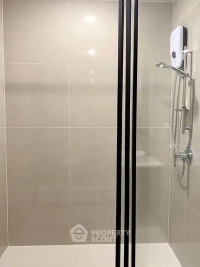 Modern bathroom with sleek shower design and neutral tiles