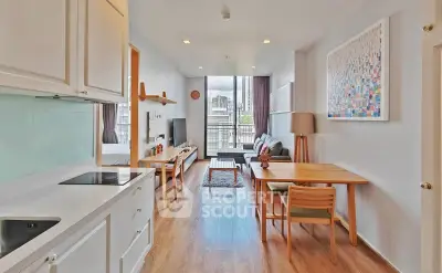 Modern open-plan living room with kitchen, featuring stylish decor and city view.