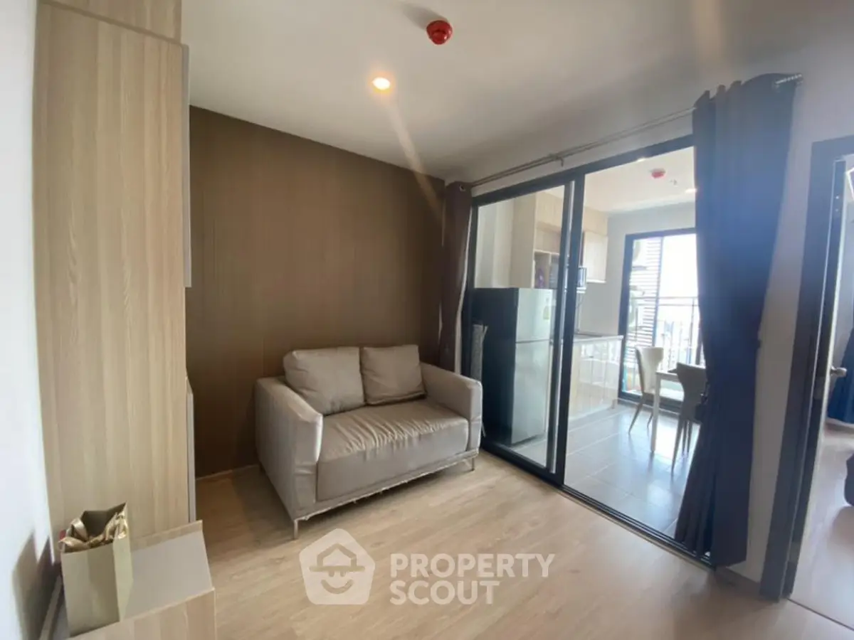 Modern living room with balcony access and cozy seating area