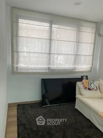 Cozy living room with large window and modern decor