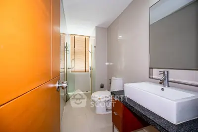 Modern bathroom with sleek fixtures and glass shower enclosure