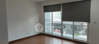 Spacious room with large windows and wooden flooring, perfect for natural light and modern living.