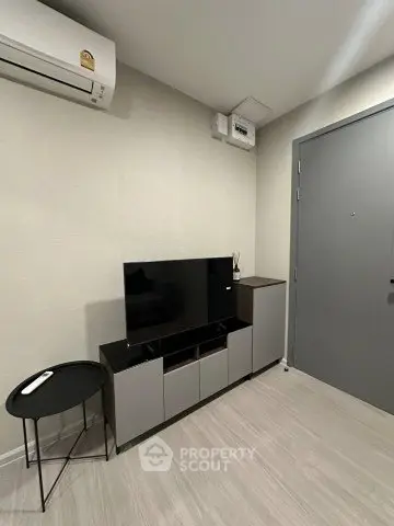 Modern living room with sleek TV stand and air conditioning unit, perfect for urban living.