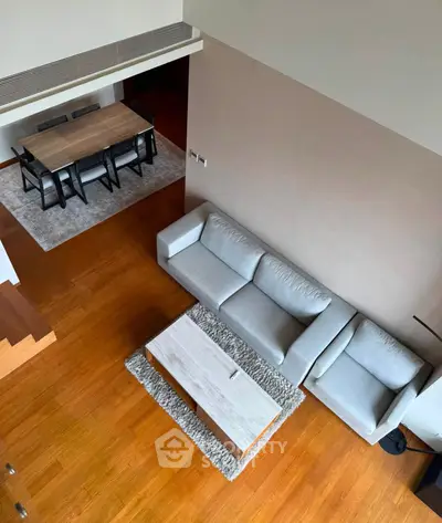 Spacious modern living room with elegant dining area and stylish furniture, perfect for entertaining.