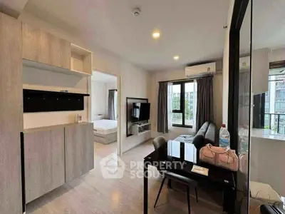 Modern apartment interior with open living room and dining area, featuring sleek furniture and large windows.