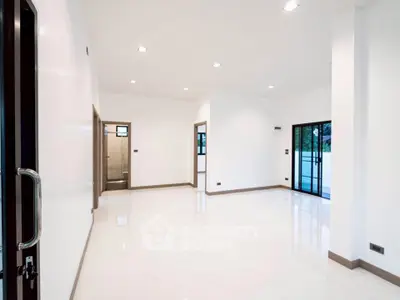 Spacious modern living room with sleek white tiles and large windows