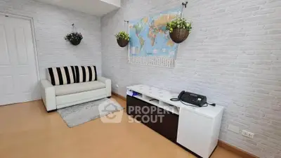 Charming living room with cozy sofa and world map decor, perfect for relaxation and inspiration.