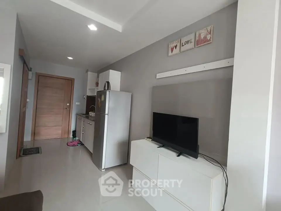 Modern living room with sleek kitchen and stylish decor