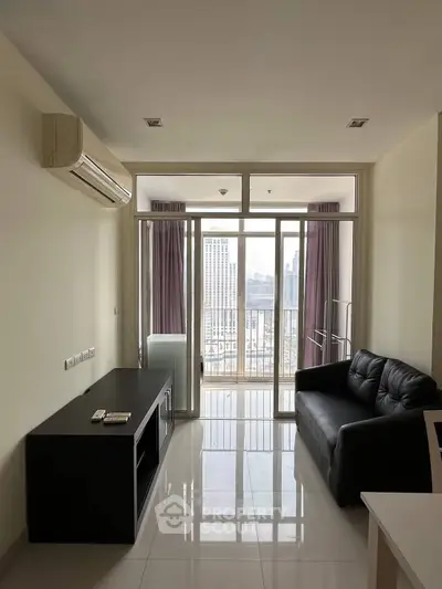 Modern living room with city view, sleek black sofa, and air conditioning in high-rise apartment.