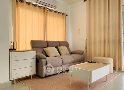 Cozy living room with modern sofa, stylish coffee table, and warm lighting, perfect for relaxation.