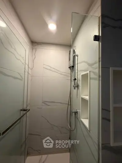 Modern bathroom with sleek glass shower and marble tiles