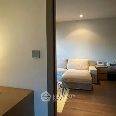 Cozy living room with modern sofa and warm lighting, perfect for relaxation.