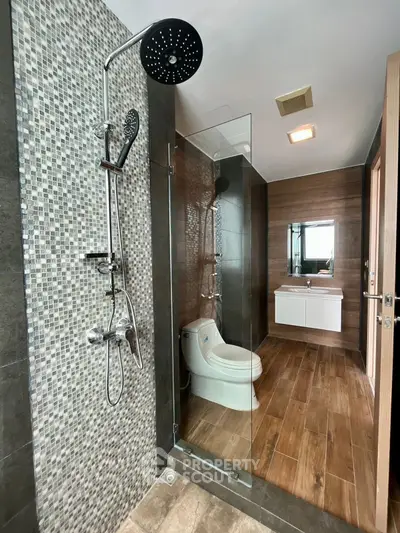 Modern bathroom with glass shower and stylish wood accents