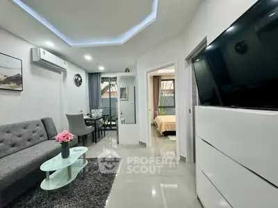 Modern living room with sleek design, featuring a cozy sofa, glass coffee table, and stylish dining area.
