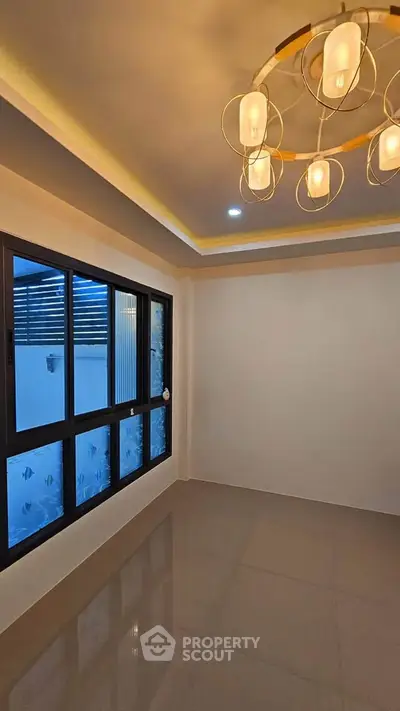 Modern interior room with elegant lighting and large window, perfect for stylish living.