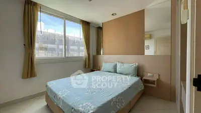 Cozy bedroom with large window and stylish decor in modern apartment