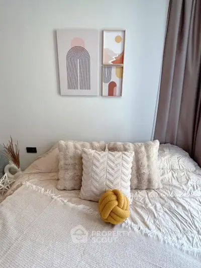 Cozy bedroom with stylish decor and modern art on the wall