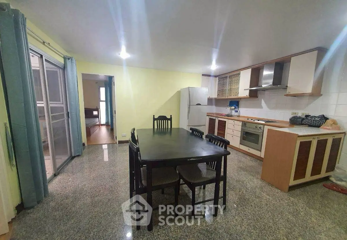 Spacious kitchen with dining area and modern appliances in open layout.
