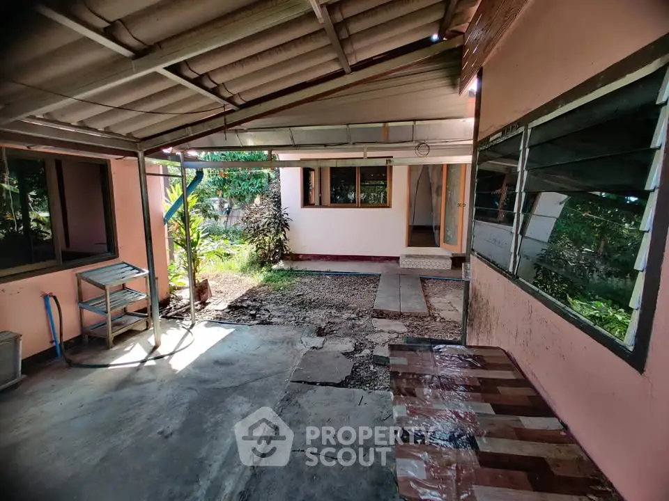 Charming outdoor patio with rustic roof and garden view