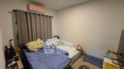 Cozy bedroom with double bed, air conditioning, and simple decor, perfect for restful nights.