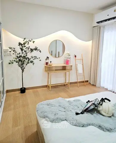 Stylish bedroom with modern decor and natural light, featuring a cozy bed and elegant furnishings.
