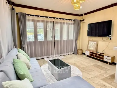 Spacious living room with modern decor and large windows for natural light