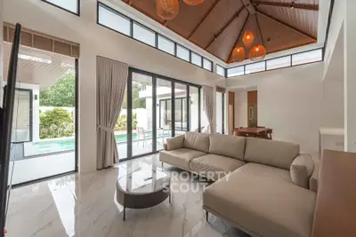 Luxurious living room with high ceilings and pool view in modern villa