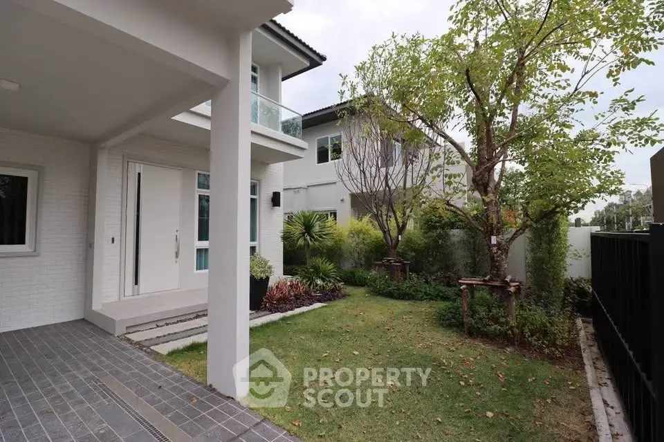 Charming modern home with lush garden and spacious patio area.