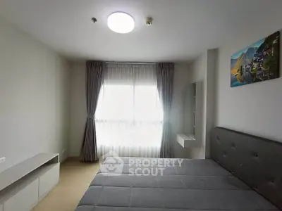 Modern bedroom with large window and stylish decor