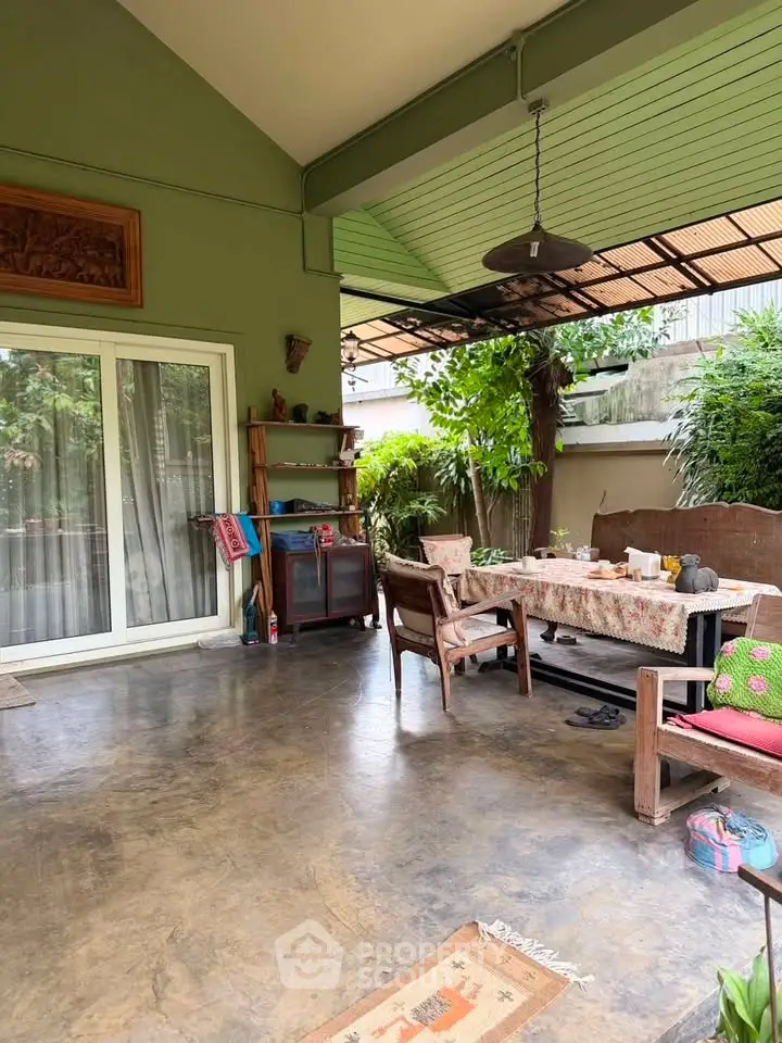 Charming outdoor patio with rustic furniture and lush greenery, perfect for relaxation and entertaining.