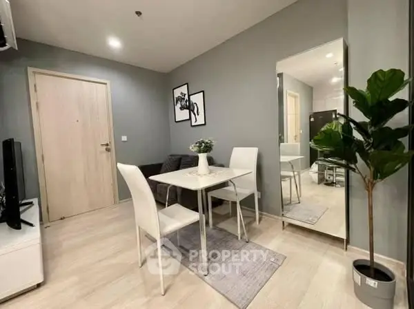 Modern living room with stylish decor and dining area in a cozy apartment.