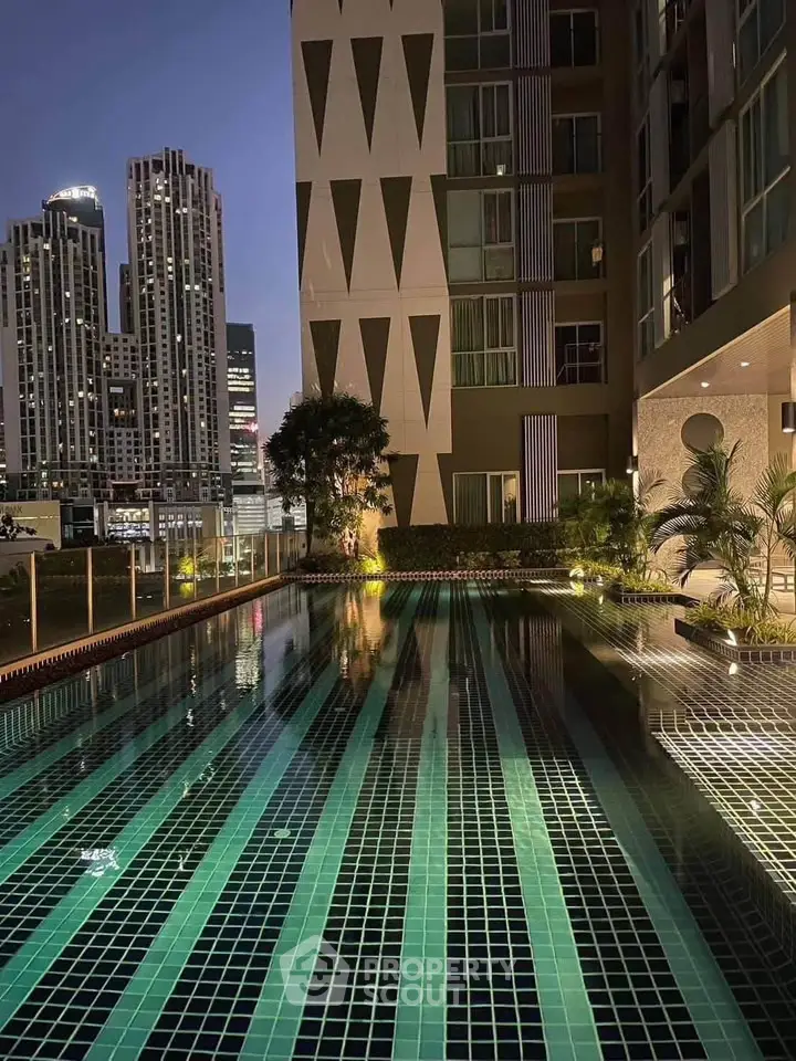 Luxurious rooftop pool with stunning city skyline views at night, perfect for urban living.