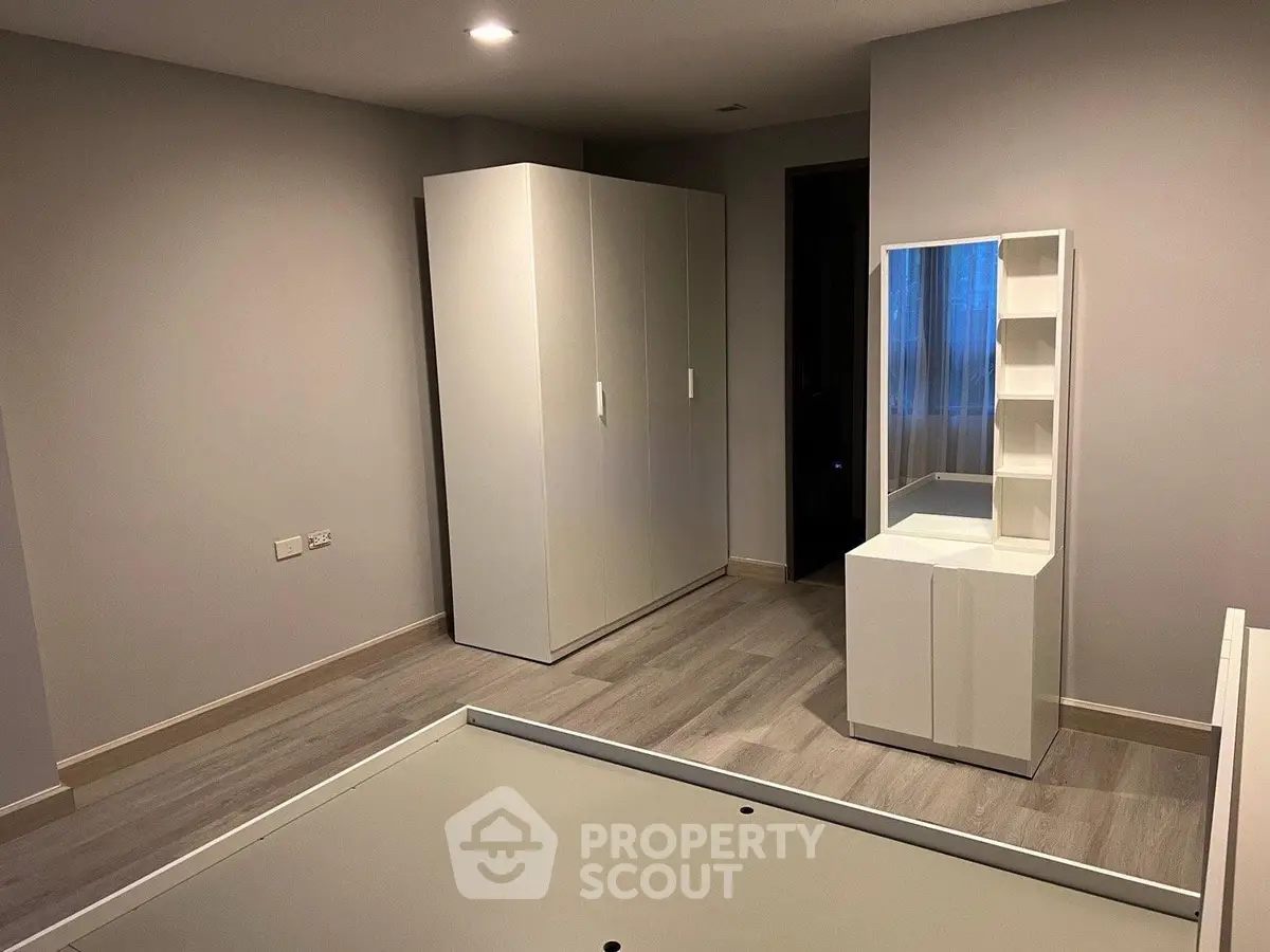 Spacious bedroom with modern wardrobe and sleek vanity unit, perfect for stylish living.