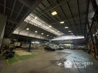 Spacious industrial warehouse with high ceilings and ample parking space