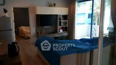 Cozy living room with modern decor and balcony access
