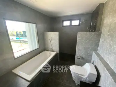 Luxurious modern bathroom with bathtub and large window view