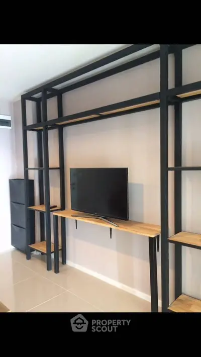 Modern living room with sleek TV stand and minimalist shelving unit.