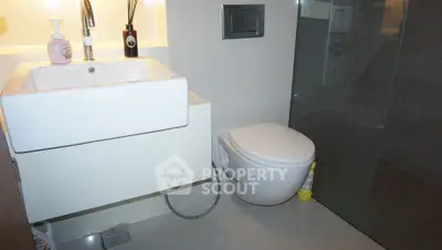 Modern bathroom with sleek fixtures and glass shower enclosure