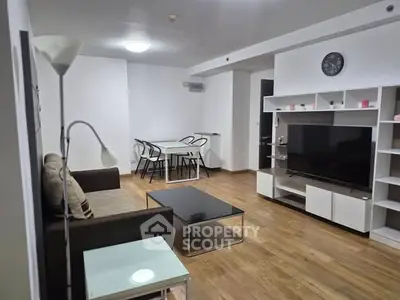 Spacious modern living room with stylish furniture and open dining area.