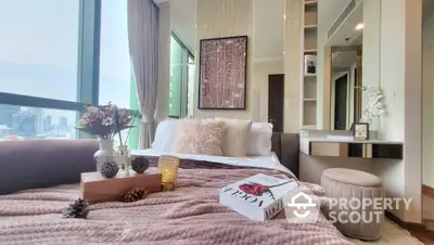 Luxurious bedroom with city view, elegant decor, and plush bedding in high-rise apartment