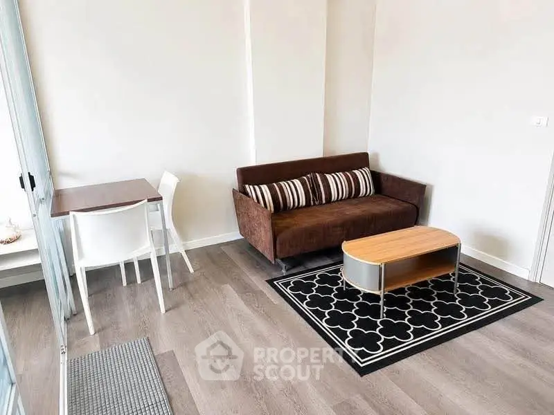 Modern living room with stylish sofa and chic coffee table on elegant rug.