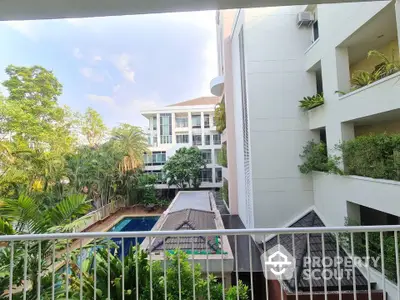 Stunning condo view with lush greenery and poolside tranquility