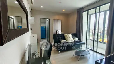 Modern living room with glass table and city view balcony in stylish apartment.