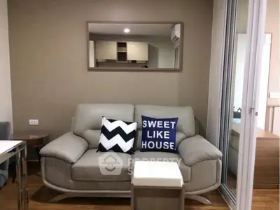 Cozy living room with stylish sofa and decorative pillows in modern apartment.