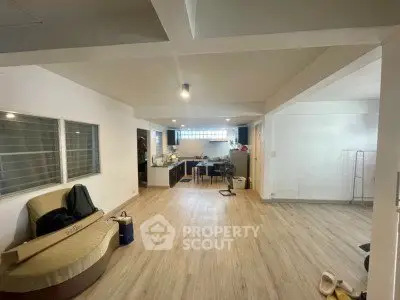 Spacious open-plan living area with modern kitchen and stylish flooring.